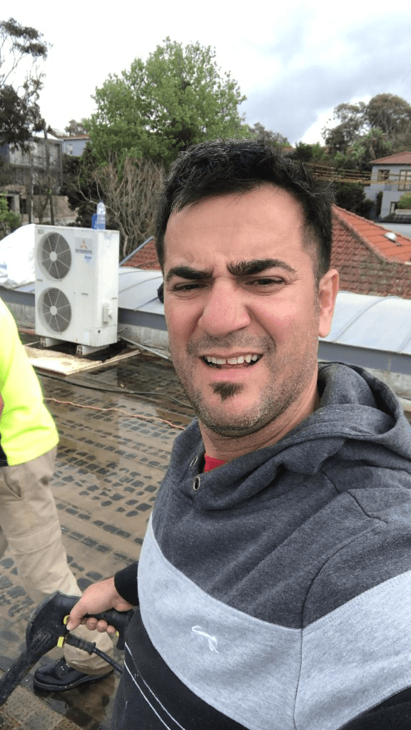 Issac Zorzano on a rooftop during waterproofing work