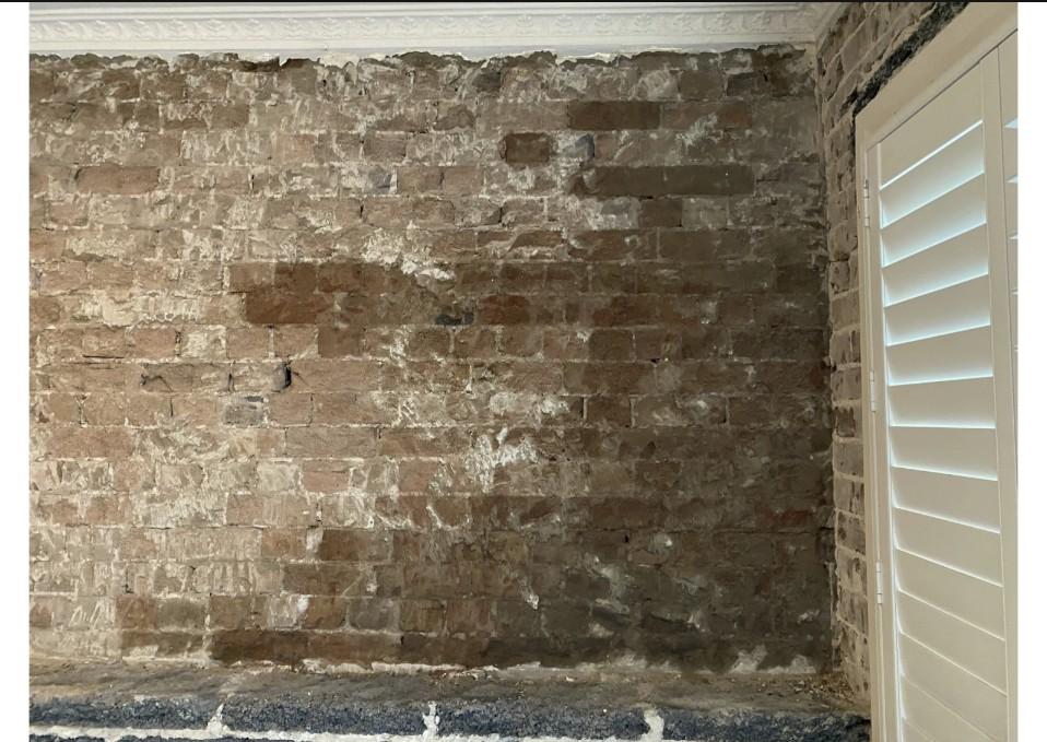 Exposed brick wall with damp patches before basement waterproofing at Barcom Ave Darlinghurst