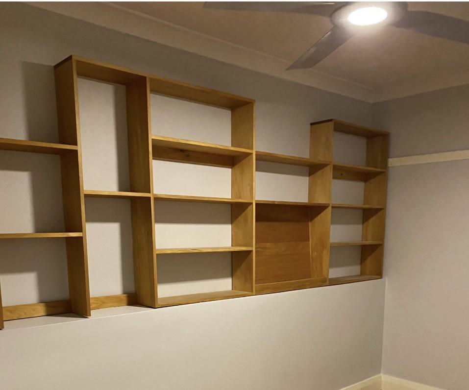 Finished dry basement room with custom shelving after negative pressure membrane waterproofing