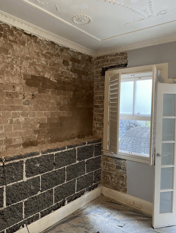 Exposed brick wall with negative pressure membrane applied at Barcom Ave Darlinghurst