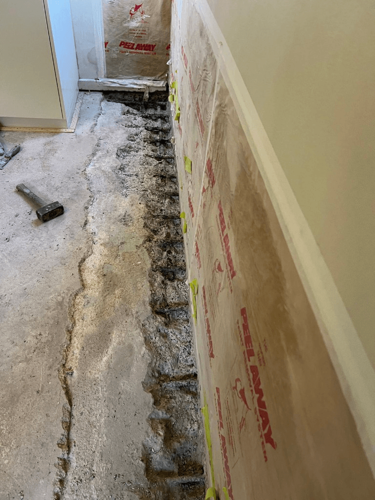 Concrete cancer caused by water ingress, with rusted reinforcement exposed