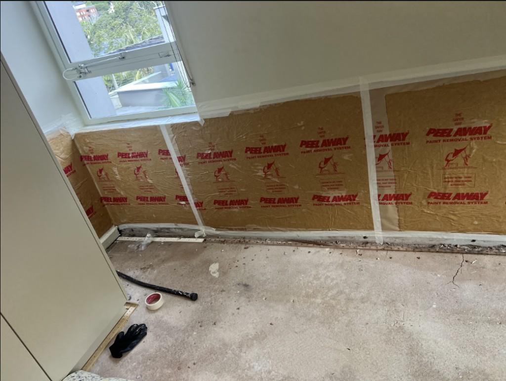 Room prepared for restoration with walls stripped back before waterproofing