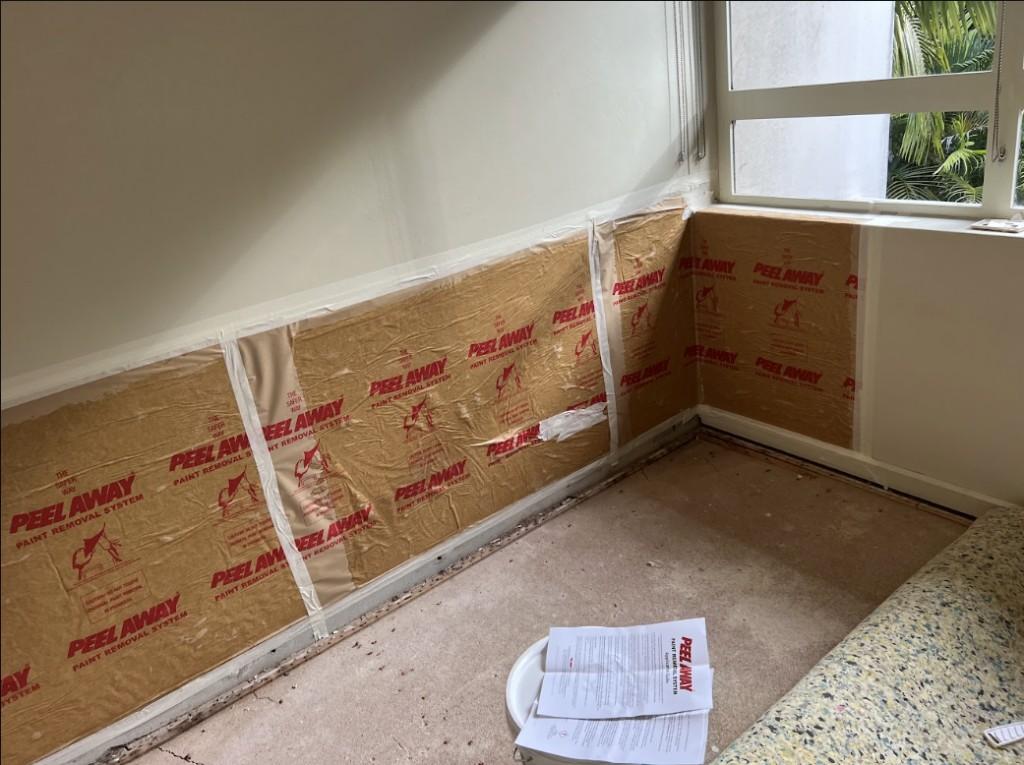 Floor stripped and walls prepared during water damage restoration