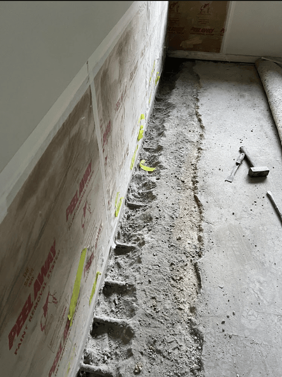 Concrete cancer exposed with rusted reinforcement in floor slab