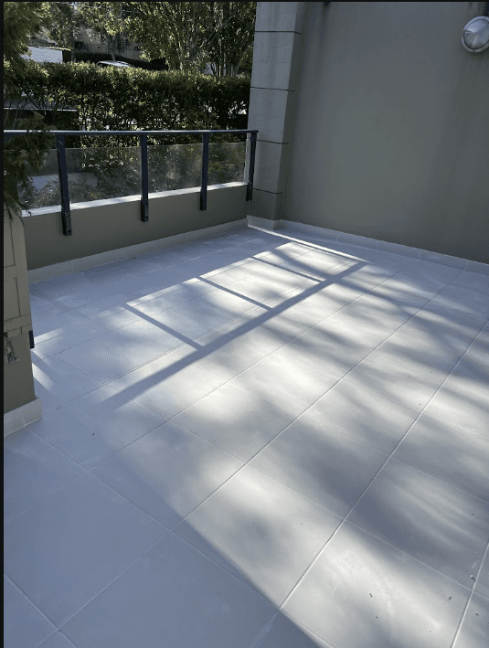 Finished tiled terrace with glass balustrade after waterproofing in Rose Bay